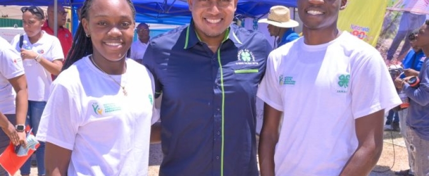 Minister of Agriculture, Fisheries and Mining, Hon. Floyd Green, shares a photo opportunity with Jamaica 4-H Clubs Champion Boy, Ishmael Smythe (right) and Champion Girl, Natoya Williams, during the recent Denbigh Agricultural, Industrial, and Food Show at the Denbigh Showground in Clarendon.