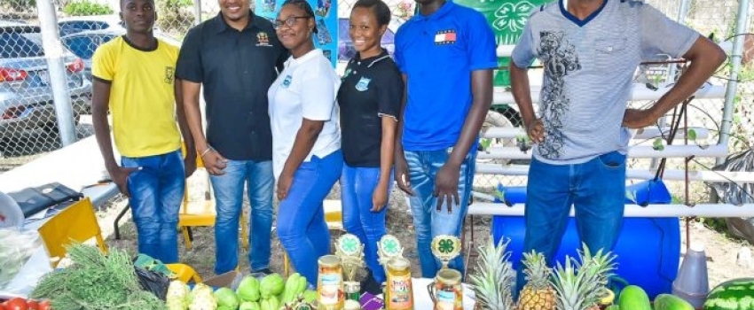 Minister of Agriculture, Fisheries and Mining, Hon. Floyd Green (second left), with representatives from the Papine High School 4-H Club during the 2023 Agricultural Show (Agrofest) for Kingston and St. Andrew. They are (from left) students, Andrew Matthewson, Grade 10; Jessica Williamson, Grade 11; Rihanna Simpson, Grade 11, and Terome Rookwooe, Grade 10; and Agricultural Science teacher, Mark Jones. The event was held on the Ministry’s playfield in Kingston, on Saturday (May 27).