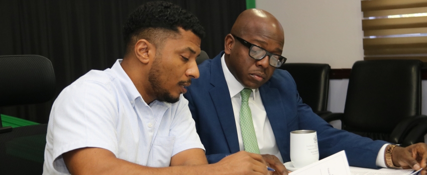 Minister of Agriculture and Fisheries, the Hon. Pearnel Charles Jr, flanked by Mr. Kevin Condappa, the Acting Principal Director of Agricultural Economic Planning & Policy,