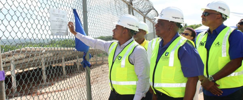 Minister of Agriculture, Fisheries and Mining, Hon Floyd Green (left), unveils a plaque containing information about the Plumwood Pumping Station Photovoltaic (PV) System at the Official Handing-Over Ceremony at the Plumwood Pumping Station in New Forest, Manchester on Thursday, June 15, 2023. Looking on from left are Minister of State at the Ministry of Agriculture, Fisheries and Mining, Hon Franklin Witter, and Managing Director at the Jamaica Social Investment Fund, Omar Sweeney.