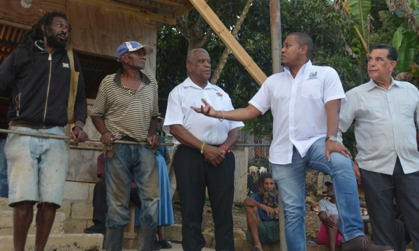 Minister of Agriculture, Fisheries and Mining, Hon. Floyd Green (second from right), converses with farmers Fabian Stennett (left) and Errol Reid (second from left), during a visit to Welcome Hall, St. James, on Thursday, January 17. Looking on are Minister of State in the Ministry of Agriculture, Fisheries and Mining, Hon. Franklin Witter (centre) and Minister of State in the Office of the Prime Minister (West), Hon. Homer Davis.