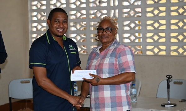 Minister of Agriculture, Fisheries and Mining, Hon. Floyd Green, presents a cash voucher to fisher, Lillian Brown, during the National Fisheries Authority’s (NFA) post- Hurricane Beryl relief programme in Whitehouse, Westmoreland, on Friday (August 30). Fisherfolk sustaining losses during the hurricane’s passage on July 3, received cash vouchers.